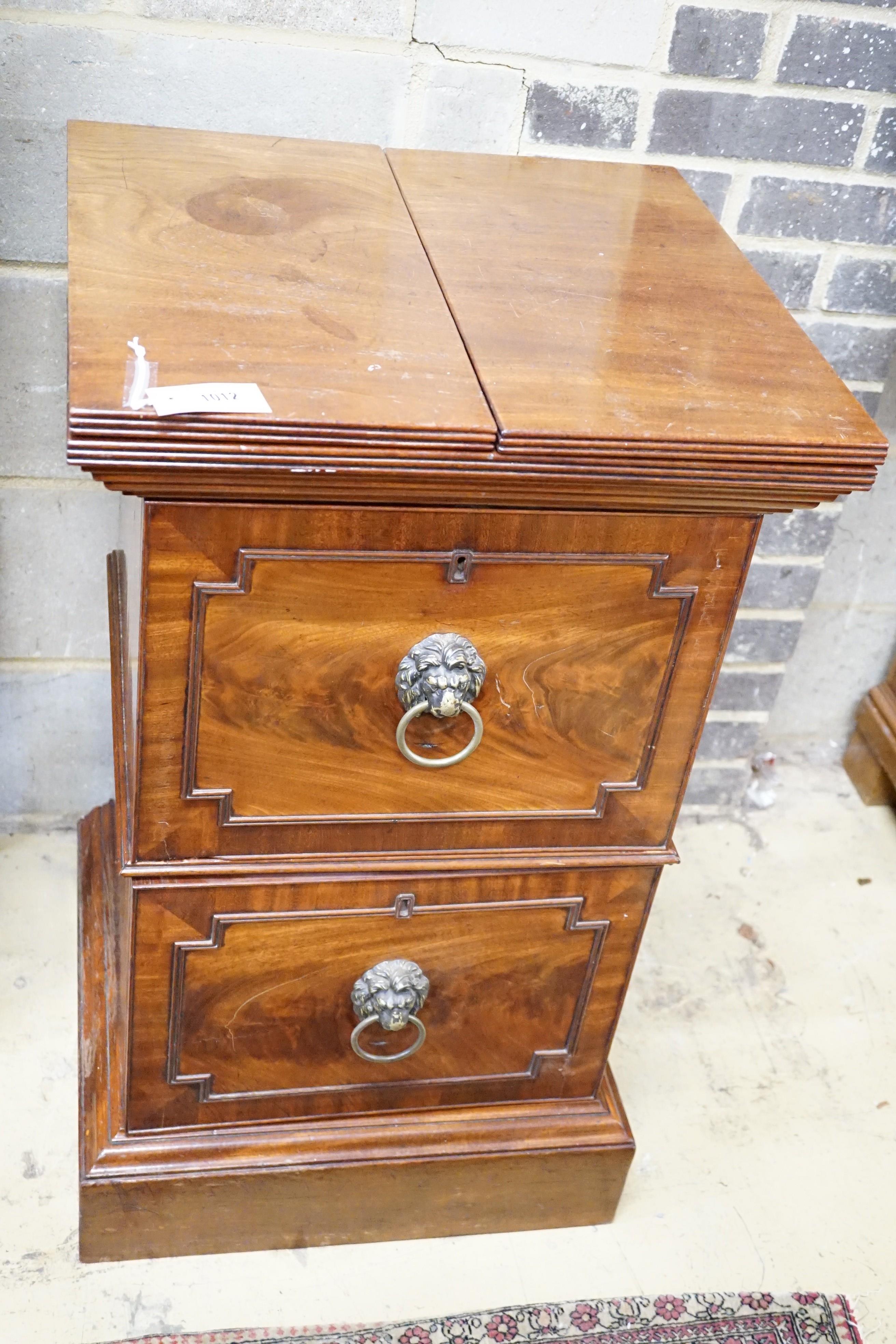 A George III mahogany pedestal designed by C. Wilson, with twin flap top, cellaret drawer now with two decanters and base cupboard, width 53cm, height 87cm